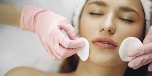 Cosmetologist treats client's skin. Woman with cosmetologist. Lady in a beauty studio.